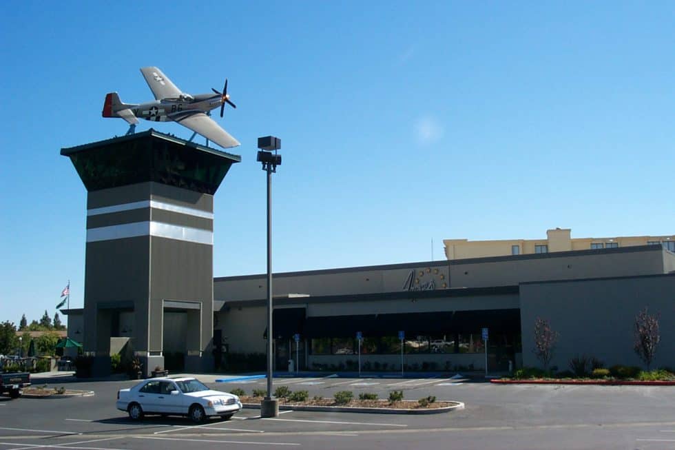 Fighter airplane mounted on a rooftop display at Lauren Anderson Design, showcasing innovative architecture and creative design elements.